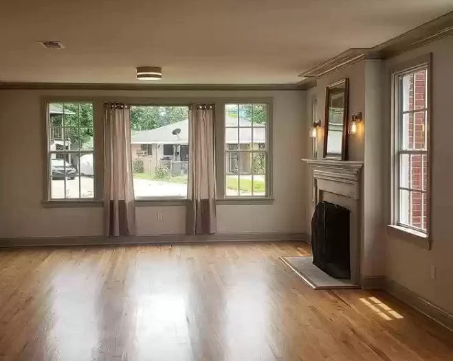 living room with some glass windows and a light brown flooring